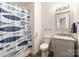 Clean bathroom with a gray vanity, marble countertop and a shower/tub combo at 2269 Winthrop Chase Dr, Charlotte, NC 28212