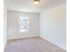 Bright bedroom with neutral colored carpet and a large window at 3521 Secrest Lndg, Monroe, NC 28110