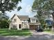 Charming two-story home with a brick facade, arched entryway, attached garage, and beautiful front yard at 3814 Topsfield Rd, Charlotte, NC 28211