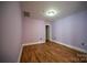 Spacious bedroom with light purple walls and wood-look floors at 505 E 6Th St # 301, Charlotte, NC 28202