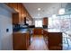 Modern kitchen with granite counters and wood cabinets at 505 E 6Th St # 301, Charlotte, NC 28202