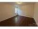 This bedroom has wood-look floors, a window letting in natural light, and neutral walls at 515 37Th Sw St, Hickory, NC 28602