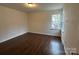 This is a bedroom with wood-look floors, neutral walls, and a window letting in natural light at 515 37Th Sw St, Hickory, NC 28602
