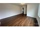 Spacious bedroom with wood floors, a neutral color scheme, and a connecting doorway at 515 37Th Sw St, Hickory, NC 28602