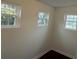 This room features 3 windows, white walls, and dark floors at 515 37Th Sw St, Hickory, NC 28602