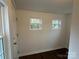 Entryway with two windows, a white front door, and dark floors at 515 37Th Sw St, Hickory, NC 28602