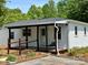 Charming exterior view of a white home with a covered porch and hanging swing at 515 37Th Sw St, Hickory, NC 28602