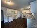 An open-concept kitchen with sleek white cabinetry, marble countertops, and stainless-steel appliances at 515 37Th Sw St, Hickory, NC 28602