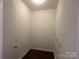 Laundry room featuring white walls, and dark floors at 515 37Th Sw St, Hickory, NC 28602