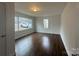 Spacious living room featuring wood-look floors, a bright window, and neutral walls at 515 37Th Sw St, Hickory, NC 28602