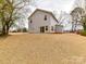 Rear exterior featuring a light-gray home and expansive backyard at 5613 Morgan Mill Rd, Monroe, NC 28110