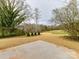 Expansive backyard with new grass and mature trees at 5613 Morgan Mill Rd, Monroe, NC 28110