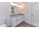 Modern bathroom with dual sinks, granite countertop and a crisp white door at 5613 Morgan Mill Rd, Monroe, NC 28110