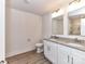 Bright bathroom featuring dual sinks, white cabinets, and a modern granite countertop with tile flooring at 5613 Morgan Mill Rd, Monroe, NC 28110