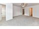 Bright, carpeted bedroom with a ceiling fan, multiple entryways and neutral walls at 5613 Morgan Mill Rd, Monroe, NC 28110