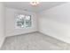 Well-lit bedroom with plush neutral carpet, a window, and neutral paint at 5613 Morgan Mill Rd, Monroe, NC 28110