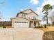 Charming two-story home boasts a spacious two-car garage and a well-manicured front yard at 5613 Morgan Mill Rd, Monroe, NC 28110