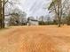 Charming two-story home featuring a welcoming front porch and a spacious yard with mature trees at 5613 Morgan Mill Rd, Monroe, NC 28110