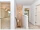 Upstairs hallway with neutral carpet leading to multiple rooms, lit by a decorative hanging light fixture at 5613 Morgan Mill Rd, Monroe, NC 28110