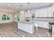 Bright kitchen with white cabinets, granite countertops, stainless steel appliances, and an island with pendant lights at 5613 Morgan Mill Rd, Monroe, NC 28110