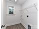 Functional laundry room featuring crisp white walls, modern vinyl floors and a window for natural light at 5613 Morgan Mill Rd, Monroe, NC 28110