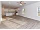 Open-concept living space with modern flooring, connecting the living and kitchen areas, filled with natural light at 5613 Morgan Mill Rd, Monroe, NC 28110