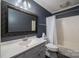 Bathroom with white vanity, tub and decorative mirror at 101 Wynnchester Rd, Gastonia, NC 28056