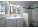 Updated bathroom with white vanity, shower, and tiled walls at 101 Wynnchester Rd, Gastonia, NC 28056