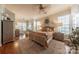 Bright and airy bedroom with hardwood floors, large windows and neutral decor at 12117 Frogs Leap Ct, Charlotte, NC 28277