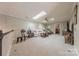 Bright bonus room with skylights, comfy seating area, and built-in shelving at 12117 Frogs Leap Ct, Charlotte, NC 28277