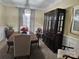 Elegant dining room featuring a large hutch and a crystal chandelier at 12205 Westbury Glen Ct # 17, Charlotte, NC 28262