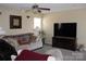 Living room featuring a sofa, TV, and ceiling fan at 12205 Westbury Glen Ct # 17, Charlotte, NC 28262