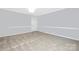 Grey walls and carpet in spacious bedroom with a door at 12491 Oak Grove Rd, Stanfield, NC 28163