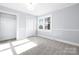 Bedroom with window, closet, and grey walls at 12491 Oak Grove Rd, Stanfield, NC 28163