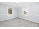 Bedroom with two windows, grey walls, and carpet flooring at 12491 Oak Grove Rd, Stanfield, NC 28163