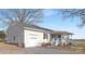 Side view of the house showing a detached garage and landscaping at 12491 Oak Grove Rd, Stanfield, NC 28163