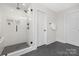 Modern bathroom showcases a walk-in shower with white subway tile and sleek fixtures, complemented by dark marble flooring at 13019 Arnold Palmer Cir # 832, Lancaster, SC 29720