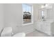 Bright bathroom featuring a toilet and vanity with modern sink, and a view to the home's exterior at 13019 Arnold Palmer Cir # 832, Lancaster, SC 29720