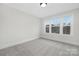 A bright bedroom featuring a wall of windows and plush carpeting throughout at 13019 Arnold Palmer Cir # 832, Lancaster, SC 29720