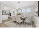 Modern dining room featuring neutral tones, a view to the kitchen and front yard, and contemporary lighting at 13019 Arnold Palmer Cir # 832, Lancaster, SC 29720