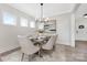 Bright dining room with modern chandelier, neutral decor, and a view to the front yard at 13019 Arnold Palmer Cir # 832, Lancaster, SC 29720