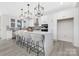 Bright, modern kitchen with white cabinets, a large island, pendant lighting and stainless steel appliances at 13019 Arnold Palmer Cir # 832, Lancaster, SC 29720