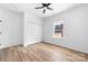 Bright bedroom features a closet, one large window, ceiling fan, and light wood-look flooring at 1306 Eddie St, Gastonia, NC 28054