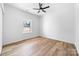 Bright bedroom features one large window, ceiling fan, and light wood-look flooring at 1306 Eddie St, Gastonia, NC 28054