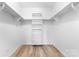 Walk-in closet with custom shelving and light wood-look flooring at 1306 Eddie St, Gastonia, NC 28054