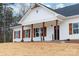 Inviting exterior showcasing a white-painted facade, rustic wood columns, complementary shutters, and a neatly kept lawn at 1306 Eddie St, Gastonia, NC 28054