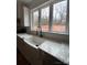 Modern farmhouse kitchen sink with a black gooseneck faucet and white quartz countertops at 1306 Eddie St, Gastonia, NC 28054