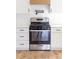 Stainless steel oven in a modern kitchen with white cabinets, drawers, a stylish black faucet, and white backsplash at 1306 Eddie St, Gastonia, NC 28054