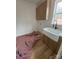 Laundry room with wood cabinets, quartz countertops and a farmhouse sink at 1306 Eddie St, Gastonia, NC 28054