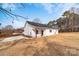 Side view of charming white home, showcasing the back porch and manicured lawn at 1306 Eddie St, Gastonia, NC 28054